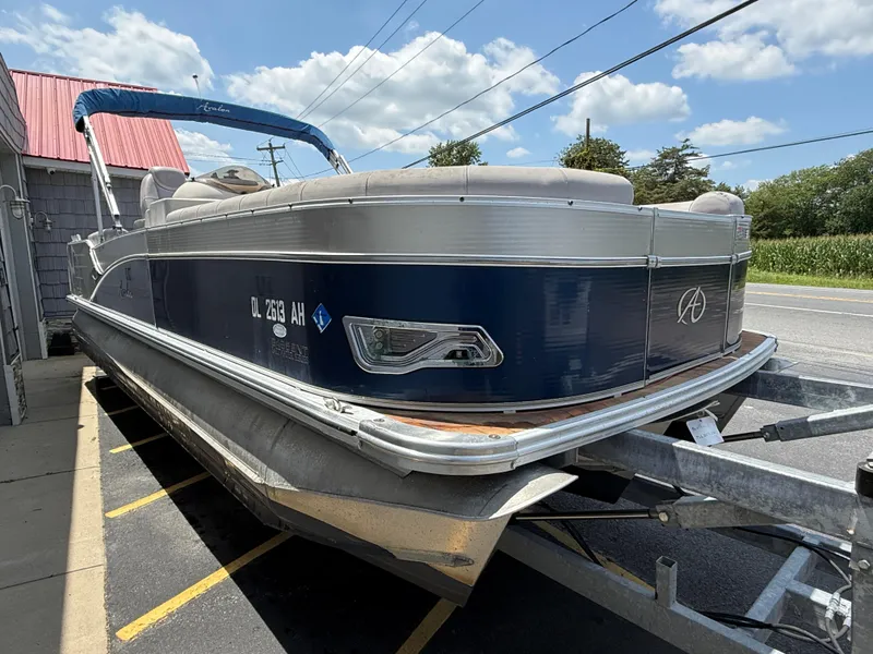 Slide: The Image of 2014 Avalon 2585 Catalina Bar Tri Toon boat on trailer, parked outdoors. - 10