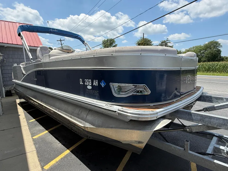 Slide: The Image of 2014 Avalon 2585 Catalina Bar Tri Toon boat on trailer, parked outdoors. - 11