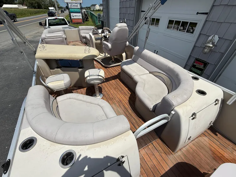 Slide: The Image of 2014 Avalon 2585 Catalina Bar Tri Toon with spacious seating and wooden deck. - 13