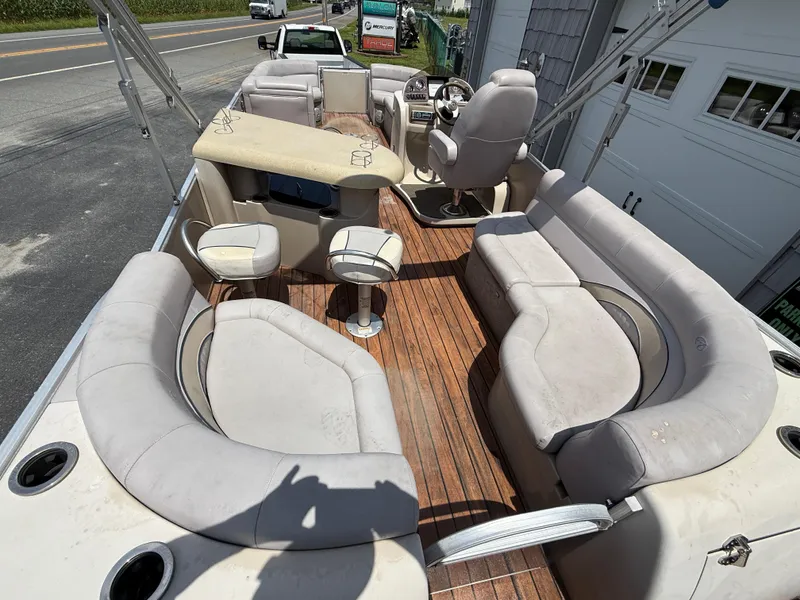 Slide: The Image of 2014 Avalon 2585 Catalina Bar Tri Toon with spacious seating and wooden deck. - 14