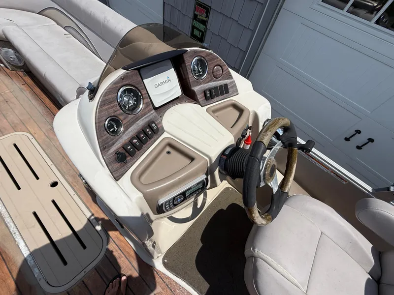 Slide: The Image of 2014 Avalon 2585 Catalina Bar boat dashboard with steering wheel and controls. - 20