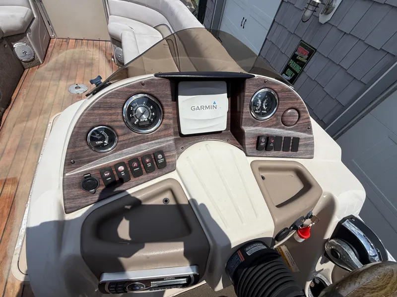 Slide: The Image of 2014 Avalon 2585 Catalina Bar dashboard with Garmin display and control panel. - 21