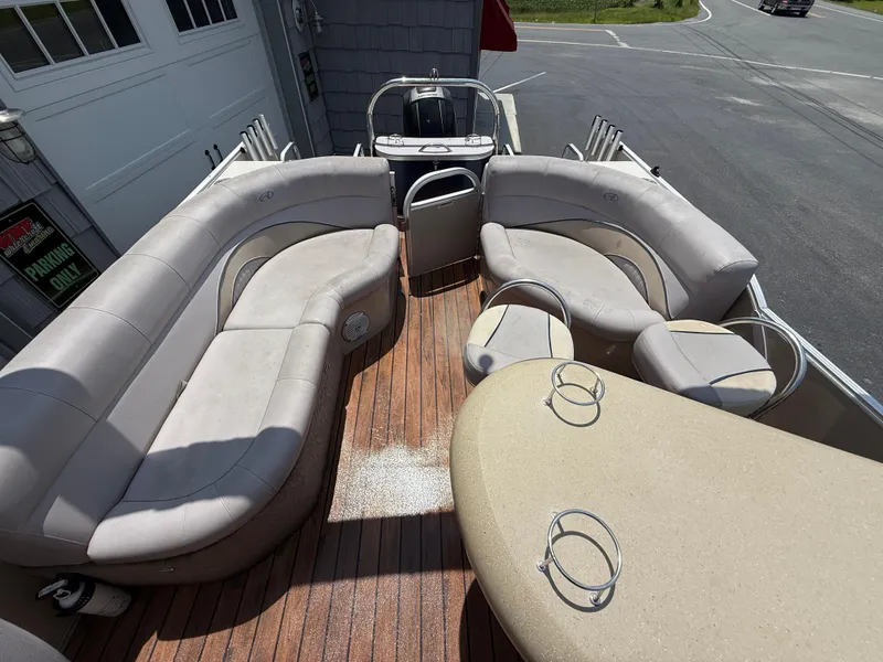Slide: The Image of 2014 Avalon 2585 Catalina Bar with plush seating and wooden deck, ideal for leisure cruising. - 23