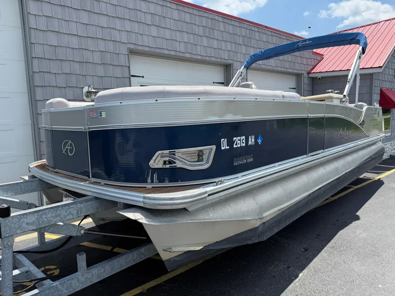 Slide: The Image of 2014 Avalon 2585 Catalina Bar Tri Toon boat on trailer, parked outside. - 3