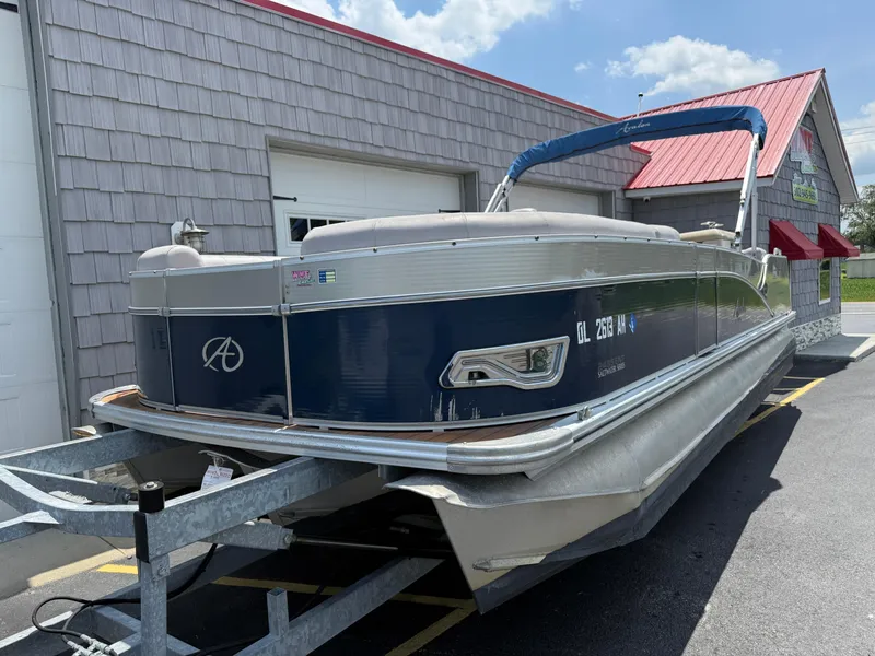 Slide: The Image of 2014 Avalon 2585 Catalina Bar Tri Toon boat on trailer outside building. - 4