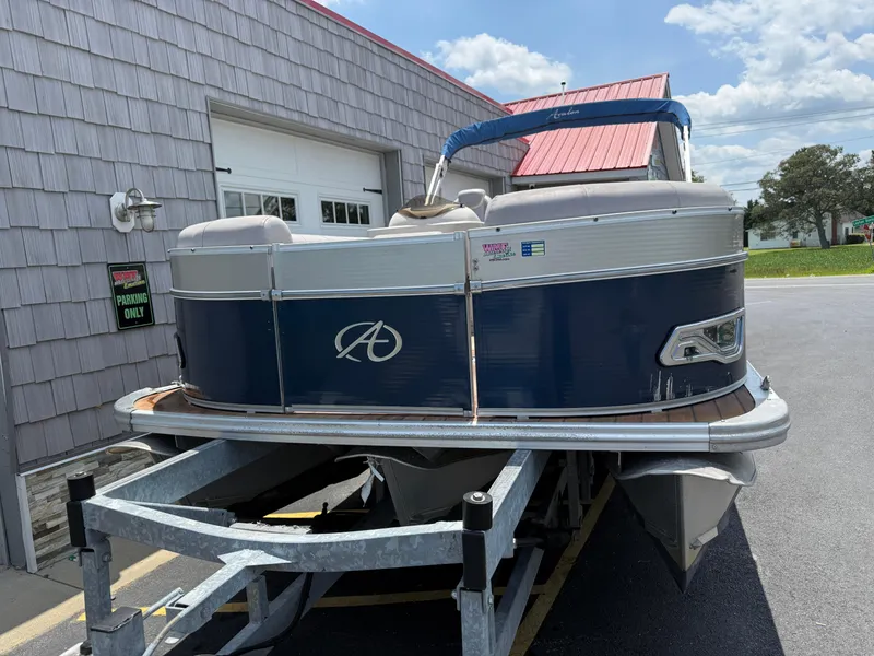Slide: The Image of 2014 Avalon 2585 Catalina Bar Tri Toon boat on trailer, parked outside. - 6