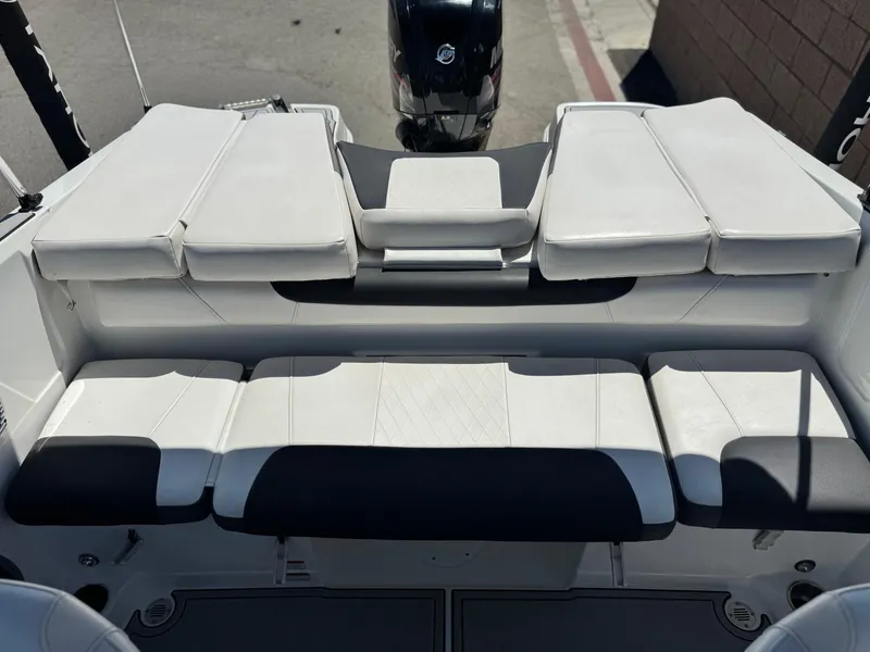 Slide: The Image of 2019 Tracker Tahoe 450 TF boat interior with cushioned seating and motor view. - 13