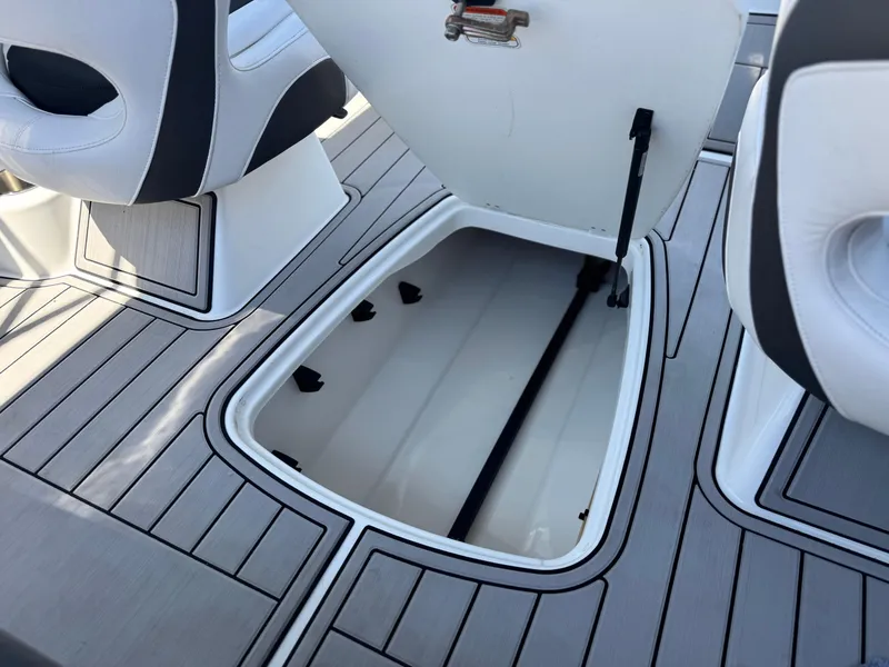 Slide: The Image of 2019 Tracker Tahoe 450 TF boat storage compartment with open hatch and seating. - 17