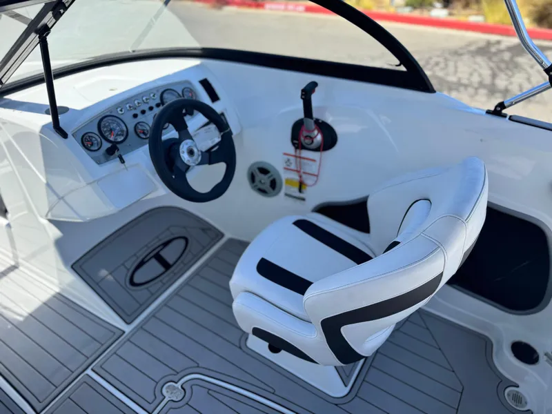 Slide: The Image of 2019 Tracker Tahoe 450 TF boat interior with steering wheel and captain's chair. - 18