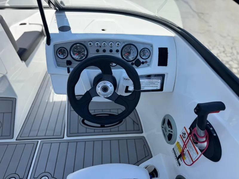 Slide: The Image of 2019 Tracker Tahoe 450 TF boat dashboard with steering wheel and controls. - 19