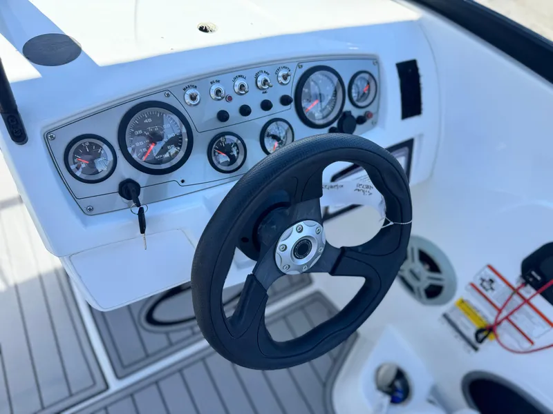 Slide: The Image of Dashboard of 2019 Tracker Tahoe 450 TF boat with steering wheel and gauges. - 20