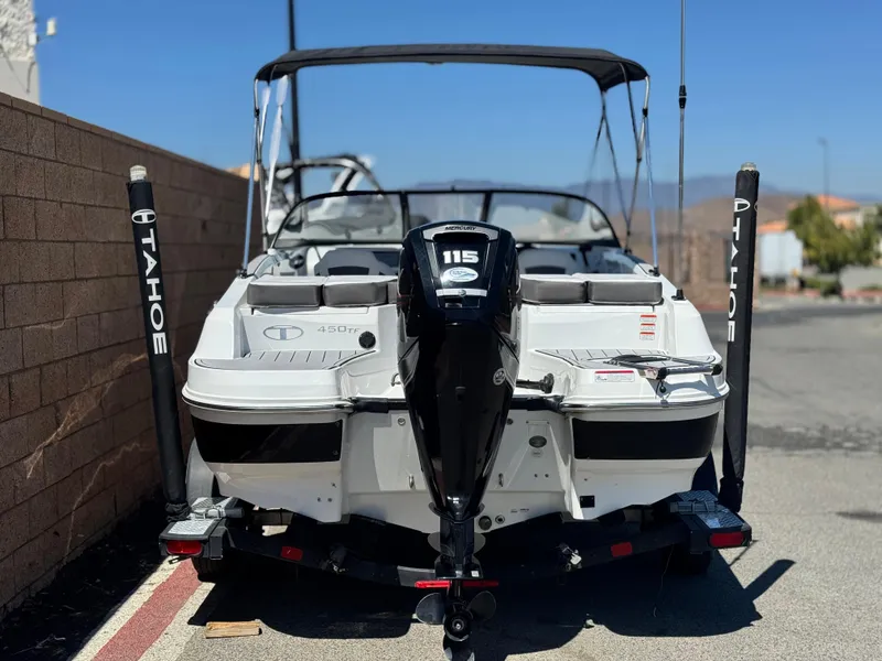 Slide: The Image of 2019 Tracker Tahoe 450 TF boat with Mercury 115 engine, parked on a trailer. - 4