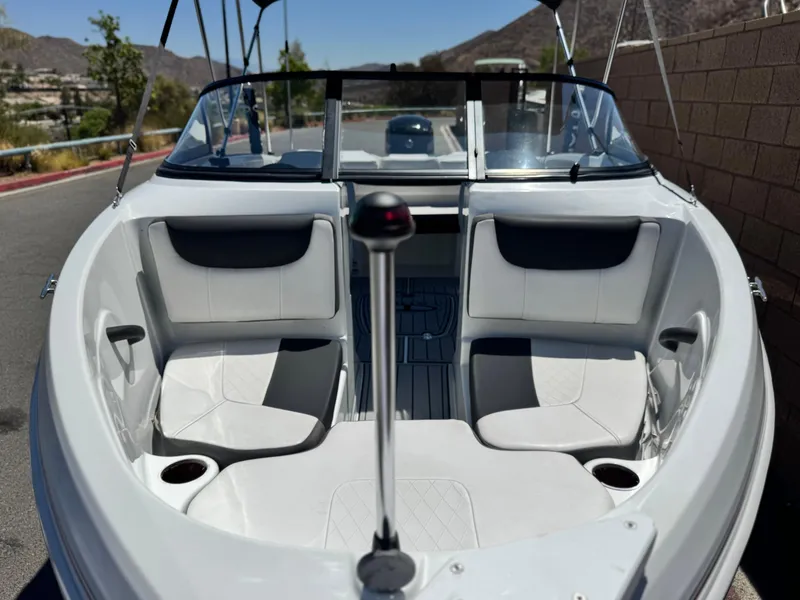 Slide: The Image of 2019 Tracker Tahoe 450 TF boat interior with white seating and cup holders. - 8