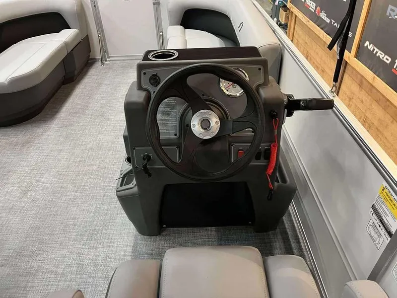 Slide: The Image of 2026 Sun Tracker PARTY BARGE® 16 DLX interior with steering console and seating. - 4