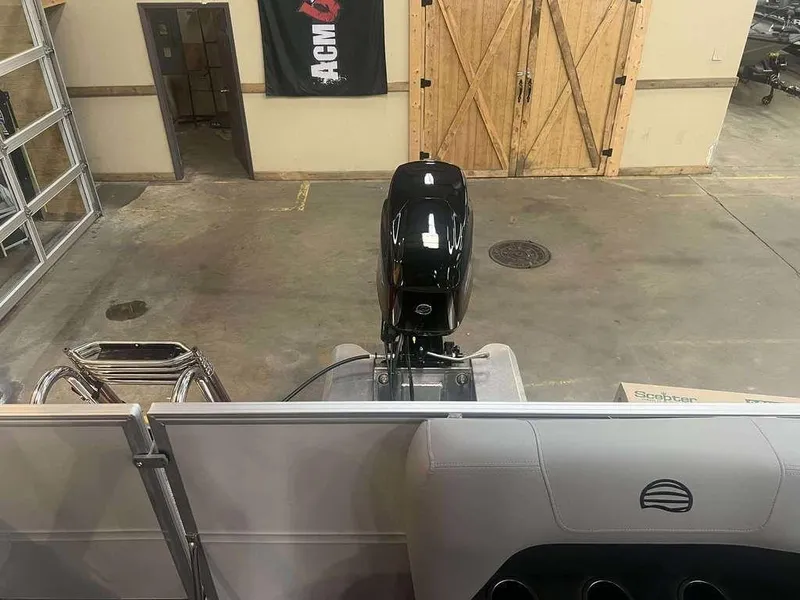 Slide: The Image of 2026 Sun Tracker PARTY BARGE® 16 DLX pontoon boat in a garage setting. - 7