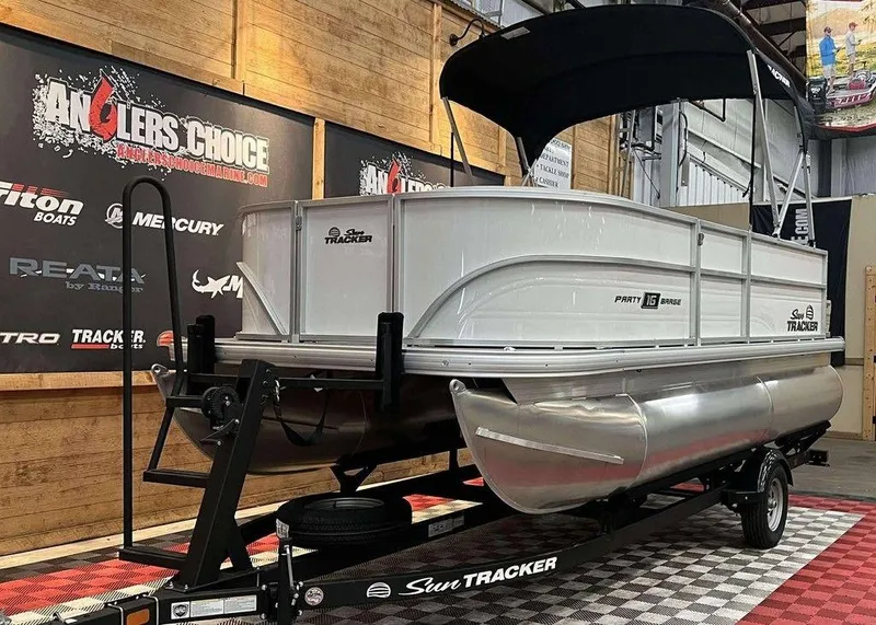 Slide: The Image of 2026 Sun Tracker PARTY BARGE® 16 DLX pontoon boat on display in showroom. - 8
