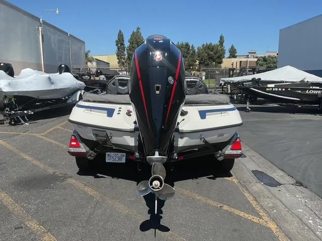 Slide: The Image of 2023 Ranger Z520R boat with powerful outboard motor, parked in a marina lot. - 13