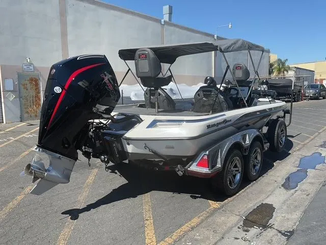 Slide: The Image of 2023 Ranger Z520R boat with powerful outboard motor, parked in urban setting. - 20