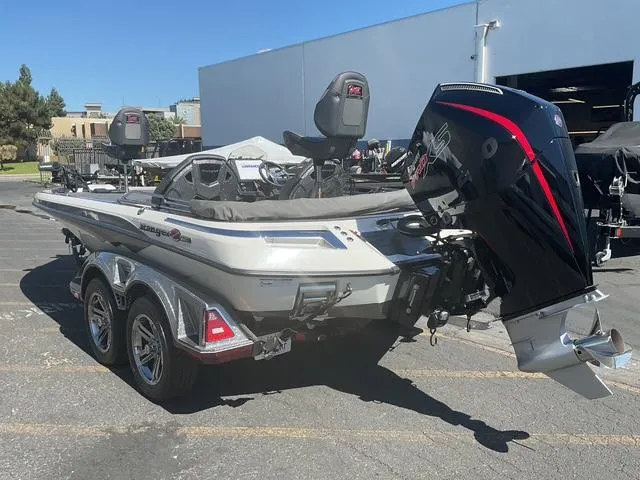 Slide: The Image of 2023 Ranger Z520R Ranger Cup Equipped boat with dual motors in a parking lot. - 8