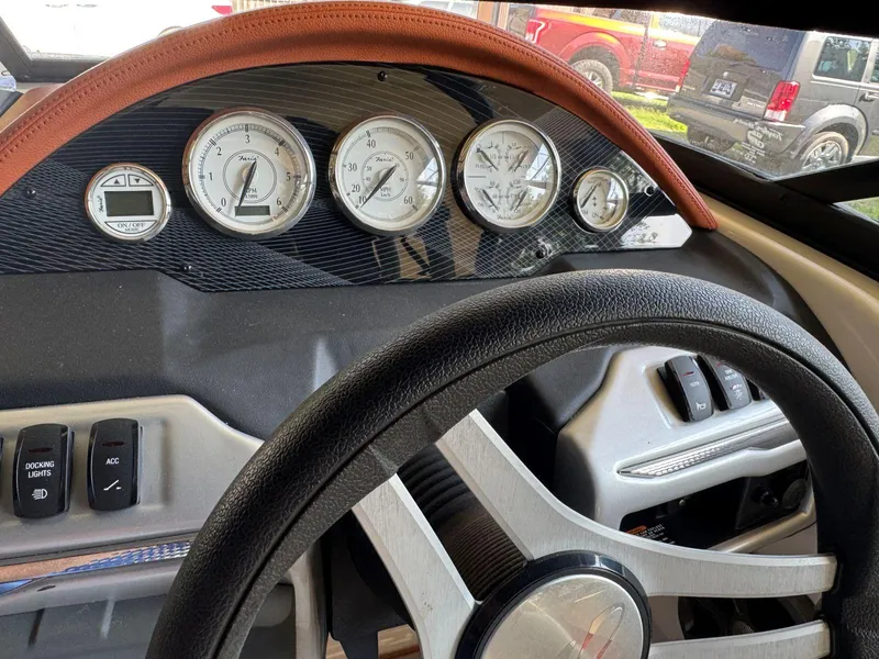 Slide: The Image of 2018 Regal 1900 ESX Bowrider dashboard with gauges and steering wheel. - 13