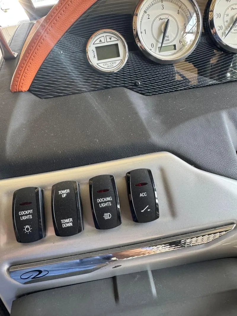 Slide: The Image of Dashboard controls of a 2018 Regal 1900 ESX Bowrider boat, featuring various switches and gauges. - 16