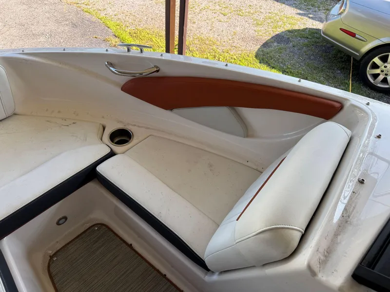 Slide: The Image of 2018 Regal 1900 ESX Bowrider interior with white and brown seating. - 18
