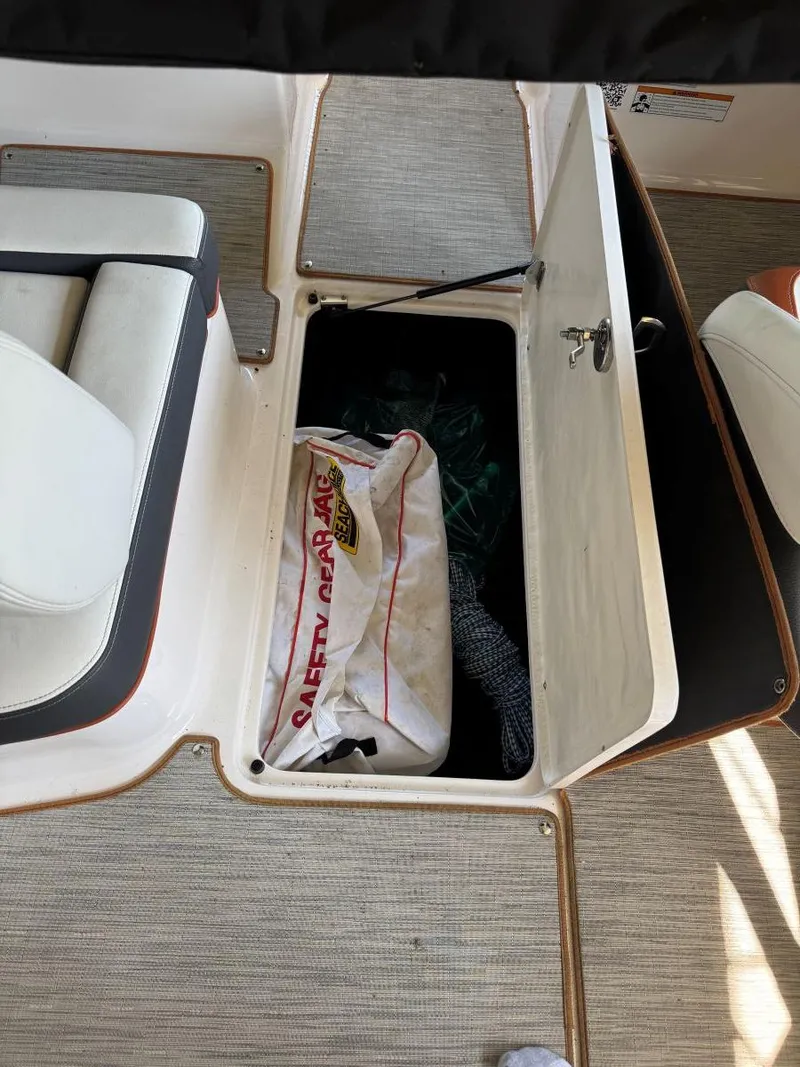 Slide: The Image of 2018 Regal 1900 ESX Bowrider storage compartment with safety gear bag. - 22