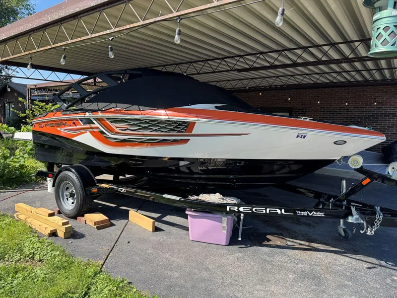 Slide: The Image of 2018 Regal 1900 ESX Bowrider boat on trailer under a metal canopy. - 23