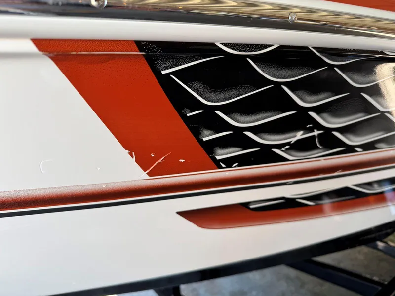 Slide: The Image of Close-up of 2018 Regal 1900 ESX Bowrider's red and black hull design. - 25