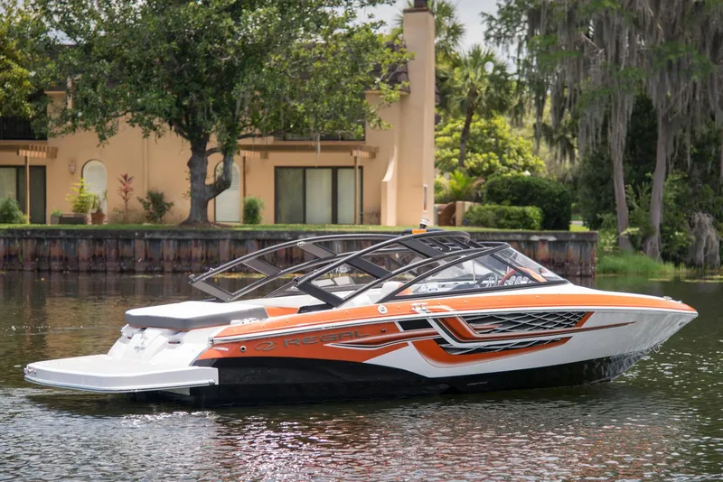 Slide: The Image of Manufacturer Provided Image: 2017 Regal 1900 ESX Bowrider boat on a calm lake near a house. - 28