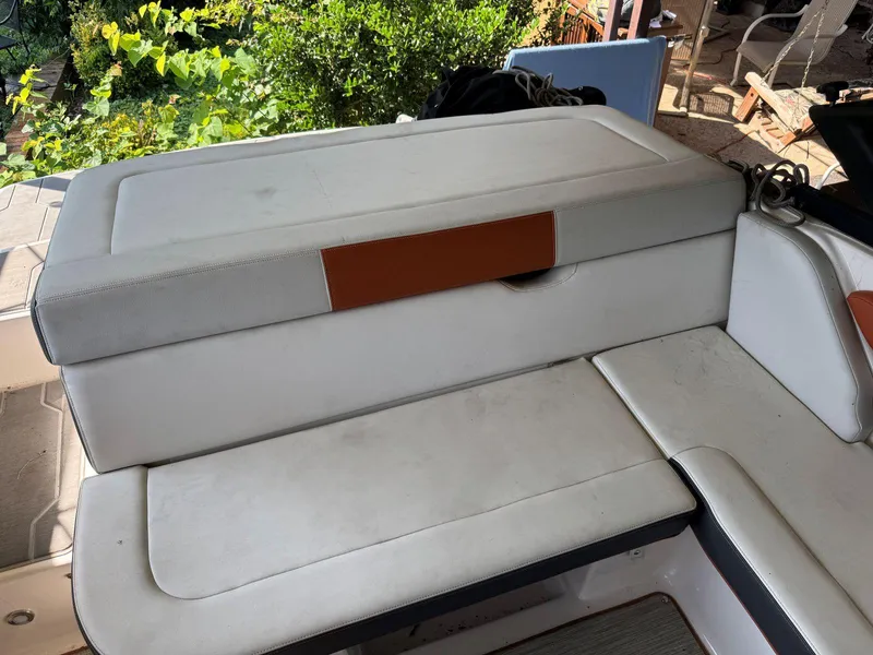 Slide: The Image of 2018 Regal 1900 ESX Bowrider boat seating area with white and brown upholstery. - 6