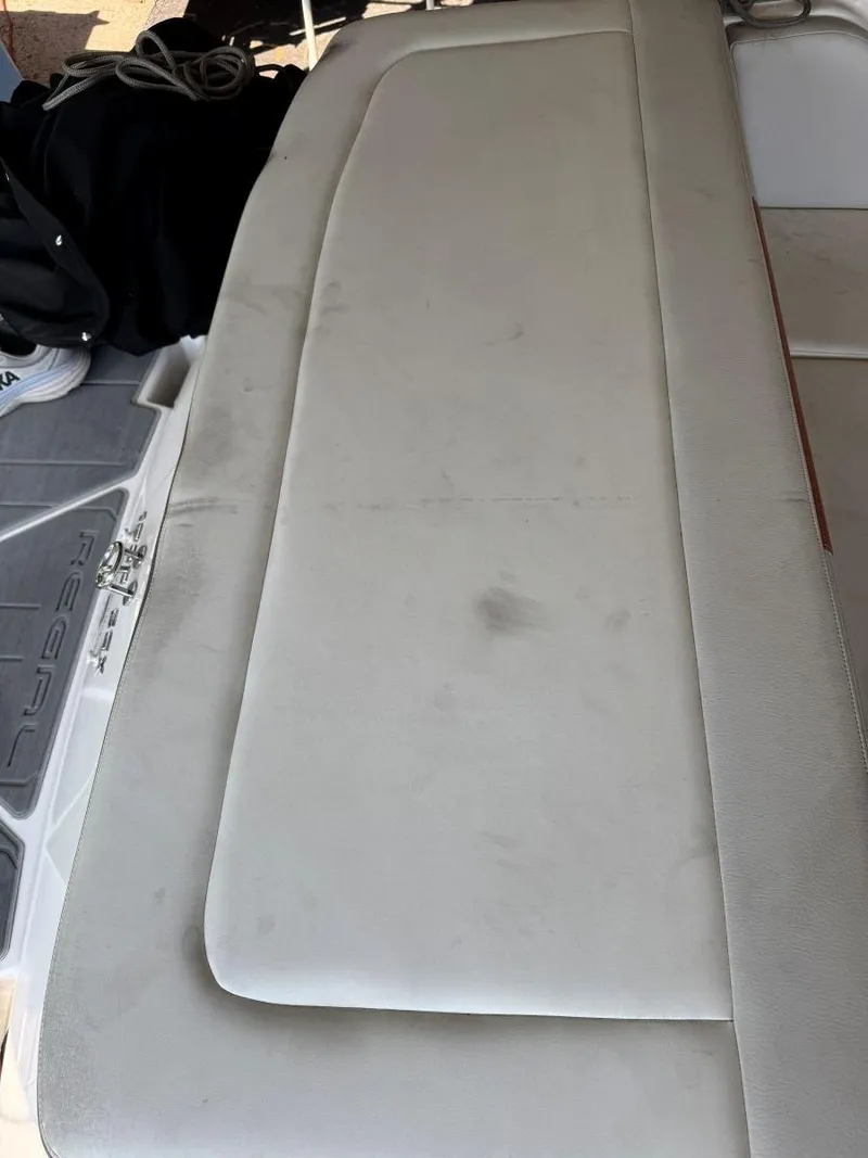 Slide: The Image of 2018 Regal 1900 ESX Bowrider boat seat with visible wear and dirt marks. - 7
