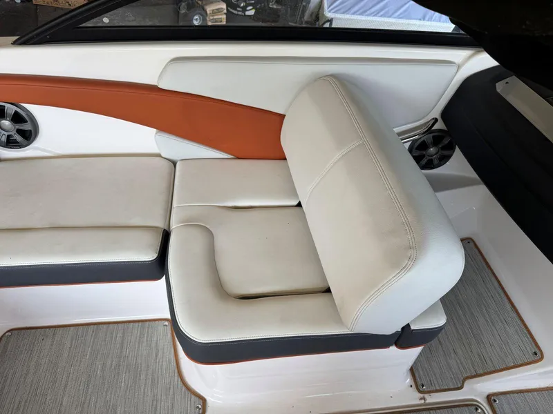 Slide: The Image of 2018 Regal 1900 ESX Bowrider interior seating with white and orange upholstery. - 9