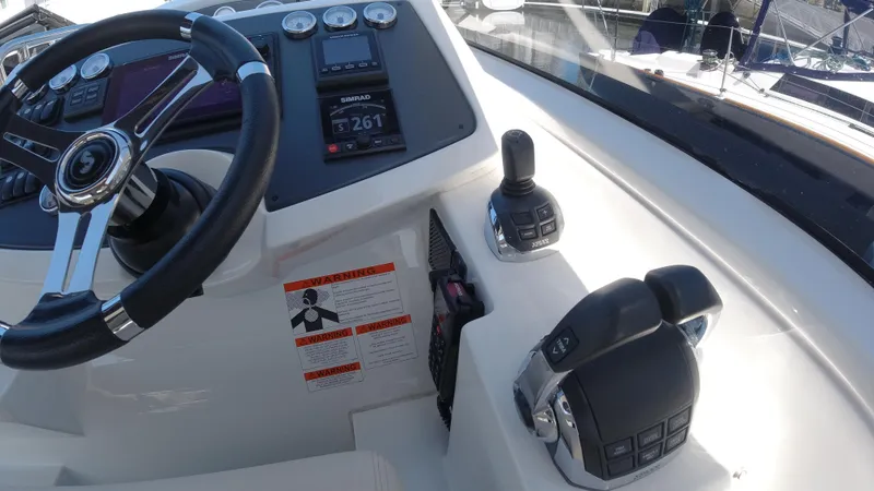 Slide: The Image of 2016 Beneteau GT35 helm station with steering wheel and control panel. - 14