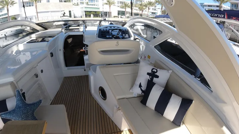 Slide: The Image of 2016 Beneteau GT35 yacht interior with plush seating and nautical-themed pillows. - 16