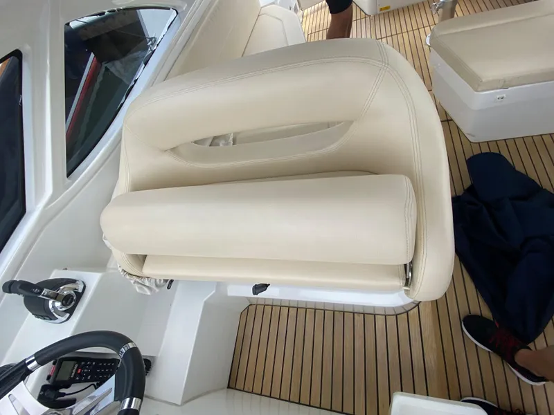 Slide: The Image of Captain's seat on a 2016 Beneteau GT35 yacht with teak flooring. - 17