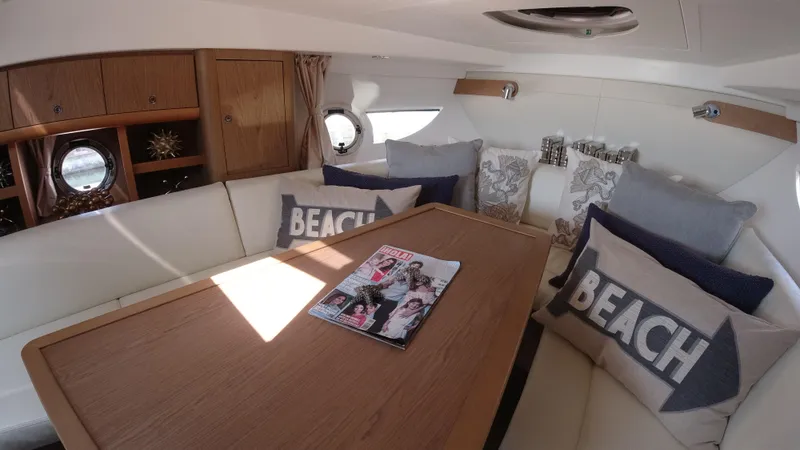 Slide: The Image of Interior of 2016 Beneteau GT35 yacht with cozy seating and decorative pillows. - 20