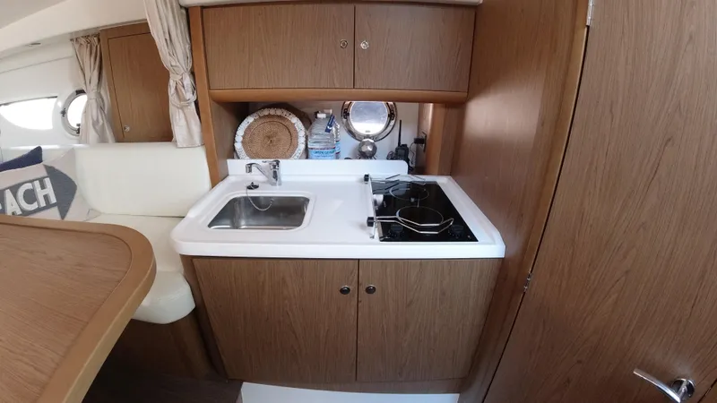 Slide: The Image of Compact kitchen area in 2016 Beneteau GT35 yacht with sink and stove. - 21