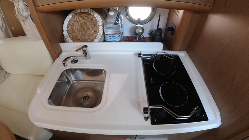 Slide: The Image of Compact kitchen area in a 2016 Beneteau GT35 yacht with sink and stove. - 22