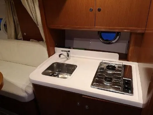 Slide: The Image of Compact kitchen area in 2016 Beneteau GT35 yacht with sink and stove. - 23