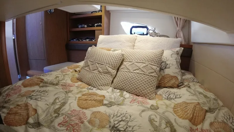 Slide: The Image of Cozy bedroom in 2016 Beneteau GT35 yacht with decorative pillows and seashell-themed bedding. - 27