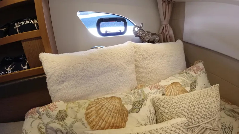 Slide: The Image of Cozy bedroom interior of 2016 Beneteau GT35 yacht with plush pillows and seashell-themed bedding. - 28