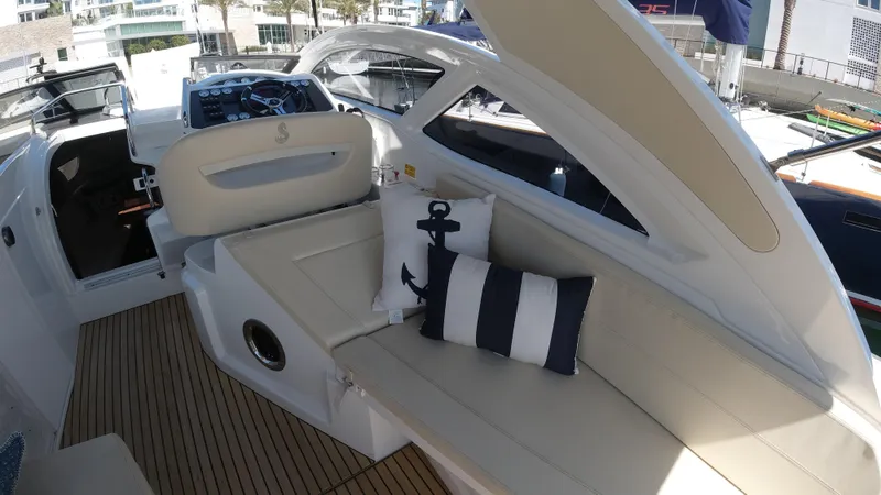 Slide: The Image of 2016 Beneteau GT35 yacht interior with white seating and nautical-themed pillows. - 31