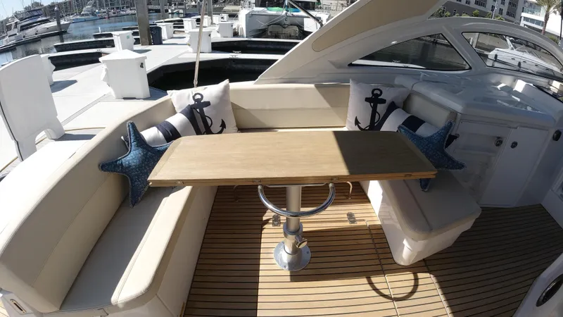 Slide: The Image of 2016 Beneteau GT35 yacht interior with cushioned seating and wooden table. - 36