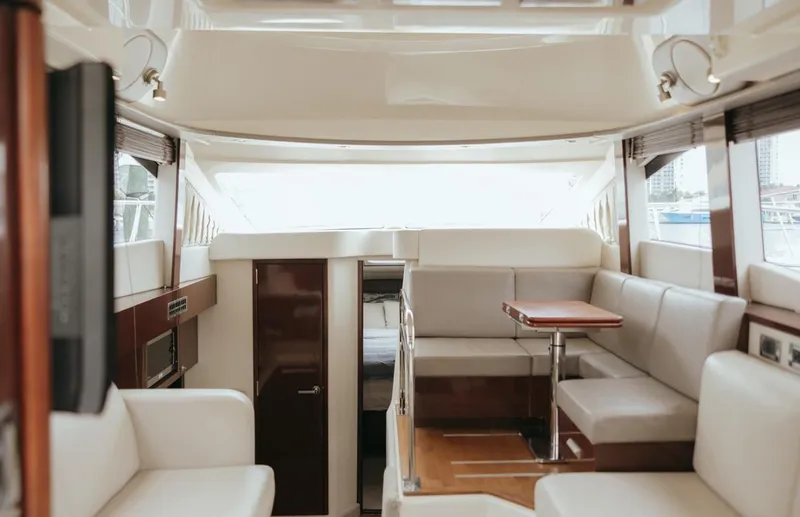 Slide: The Image of Luxurious interior of 2010 Sea Ray 390 Sedan Bridge yacht with elegant seating and table. - 10