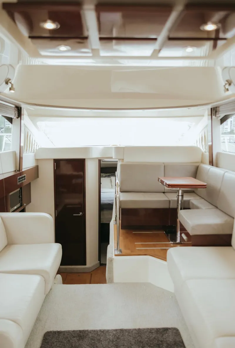 Slide: The Image of Luxurious interior of 2010 Sea Ray 390 Sedan Bridge yacht with elegant seating and wood accents. - 11