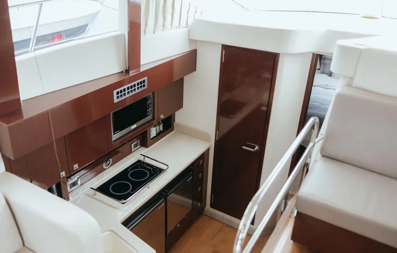 Slide: The Image of Interior of 2010 Sea Ray 390 Sedan Bridge yacht with modern kitchen amenities. - 12