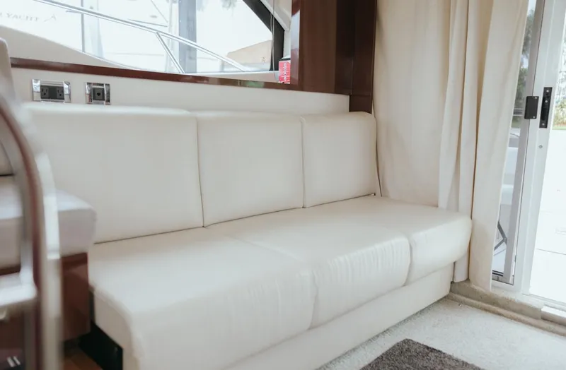 Slide: The Image of Interior of 2010 Sea Ray 390 Sedan Bridge with white leather sofa and sliding glass door. - 13