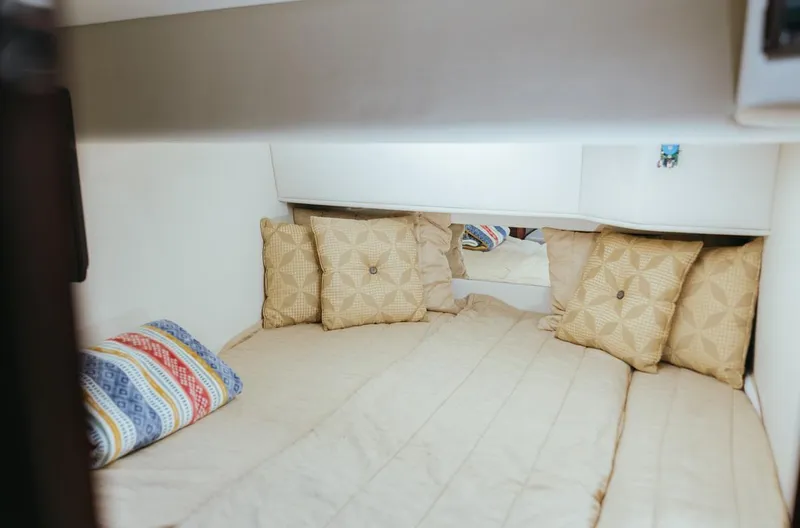 Slide: The Image of Cozy cabin interior of 2010 Sea Ray 390 Sedan Bridge with decorative pillows. - 20