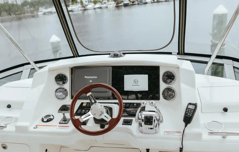 Slide: The Image of Helm of 2010 Sea Ray 390 Sedan Bridge with navigation equipment and controls. - 23